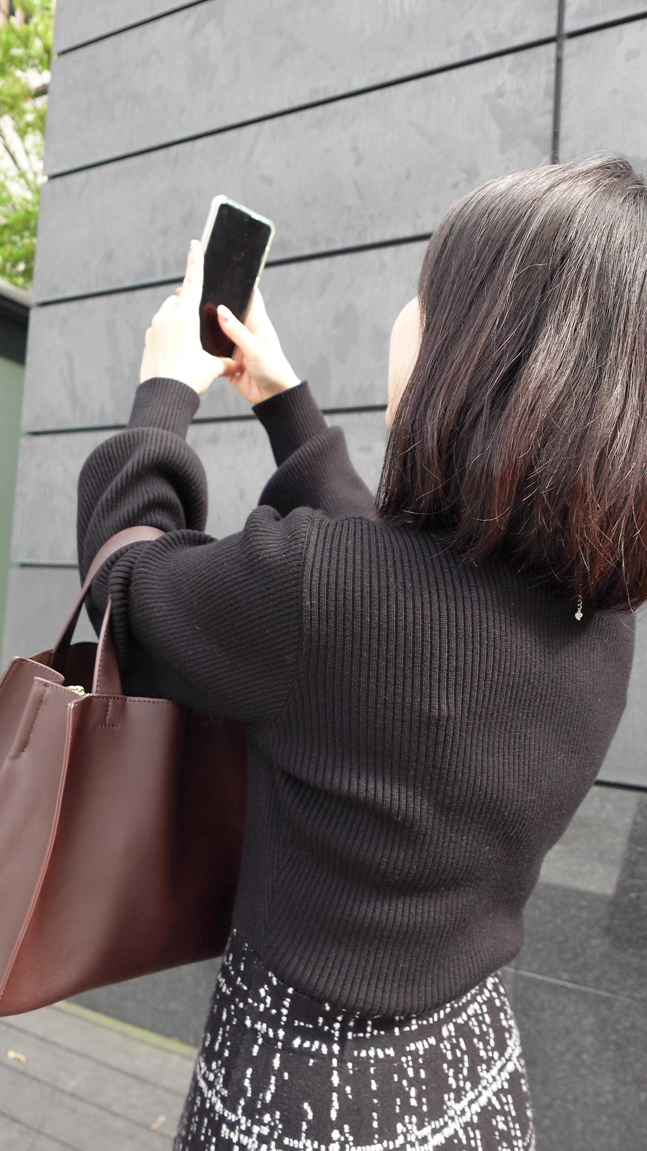 スマートフォンでお出かけ先を撮影する女性のイメージ